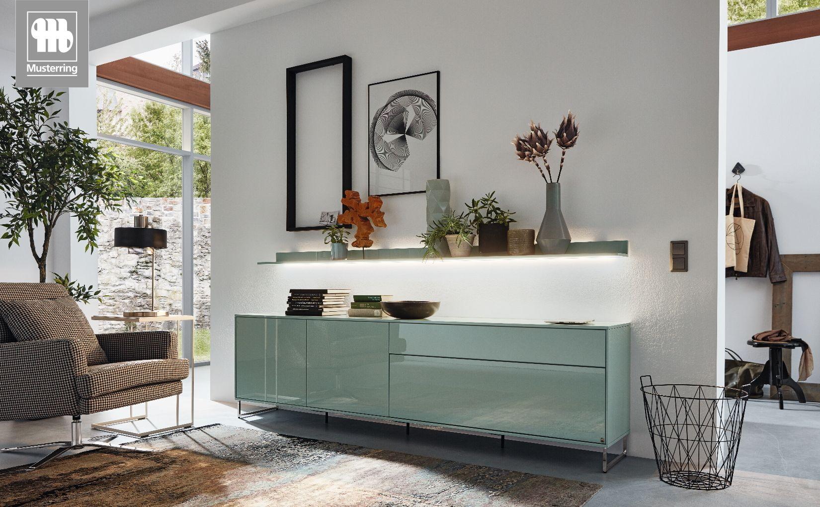 MR-Kara-Frame-Sideboard von Musterring in Mintglas mit beleuchtetem Wandboard.